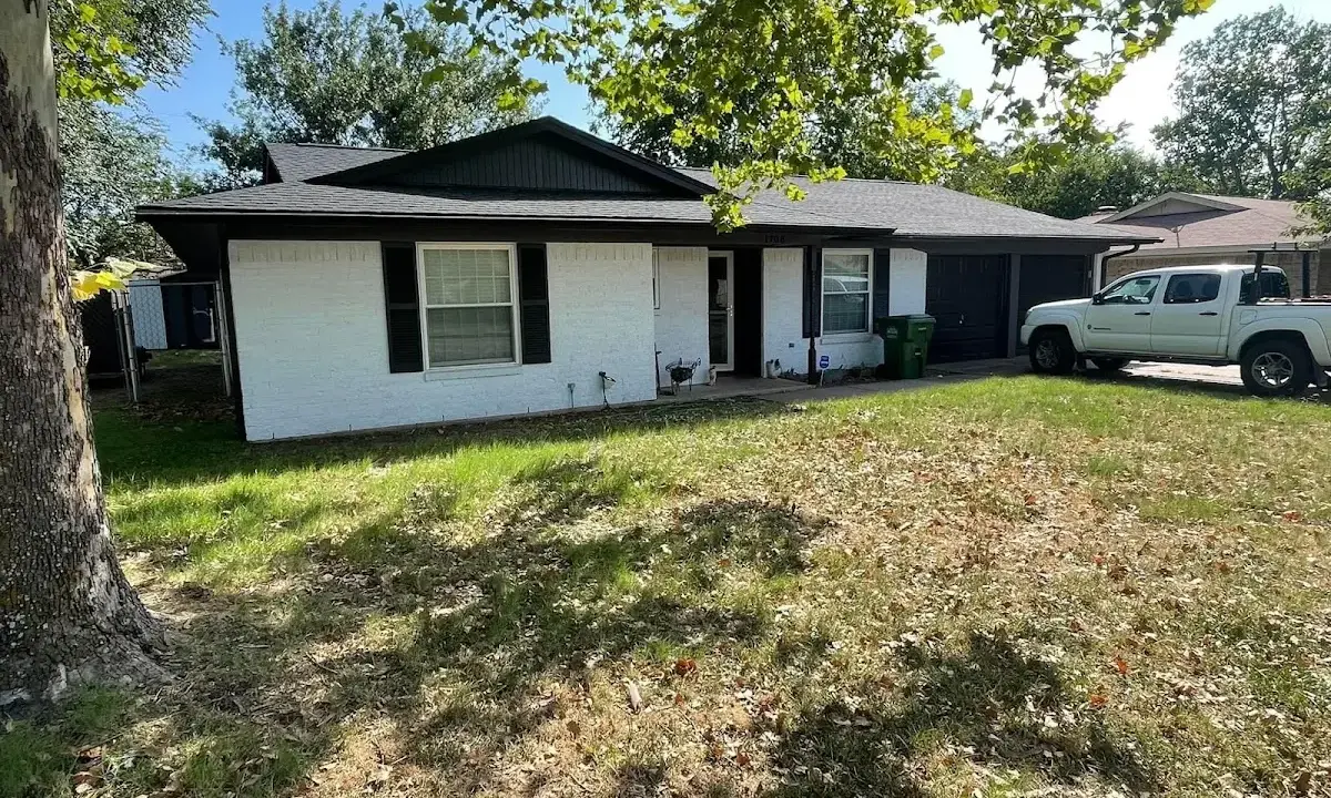 Professional roofing crew working on a residential roof in Indiantown